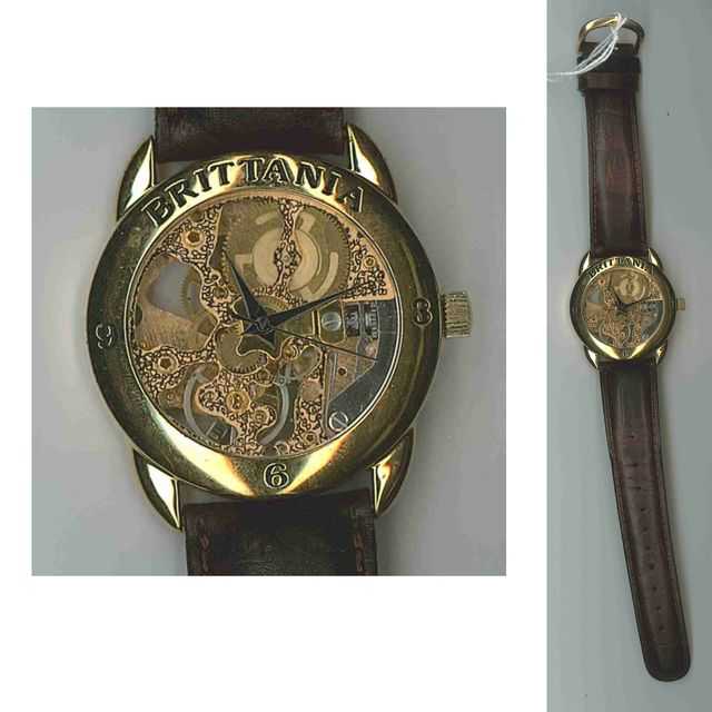 BRITANIA. MODELE SQUELETTE. MONTRE D'HOMME EN PLAQUE OR. BOITIER CIRCULAIRE. MOUVEMENT MECANIQUE. BRACELET EN CUIR MARRON.