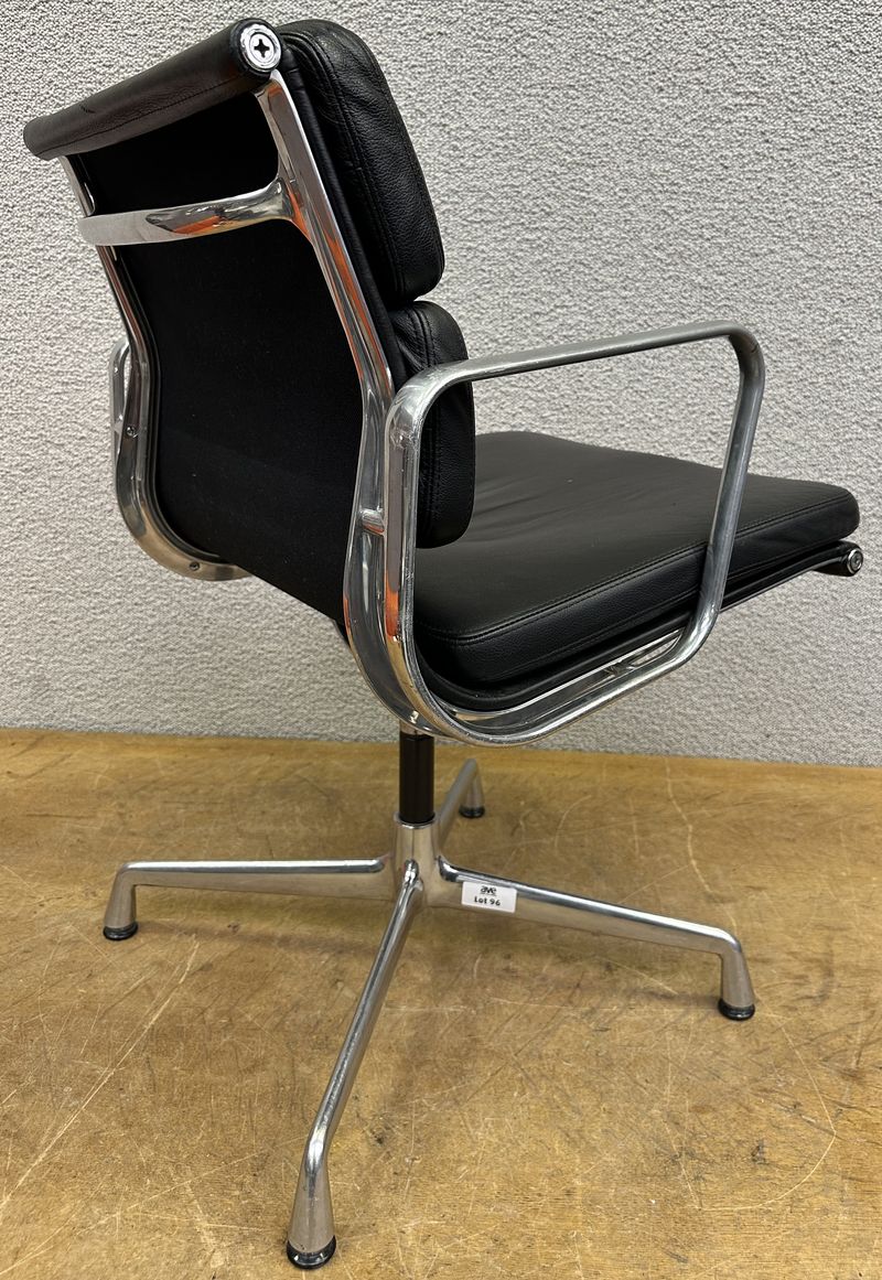 FAUTEUIL PIVOTANT DESIGN CHARLES ET RAY EAMES MODELE SOFT PAD EA208 EDITION VITRA, STRUCTURE EN ALUMINIUM, GARNITURE EN CUIR NOIR REPOSANT SUR UN PIETEMENT EN ETOILE A 4 BRANCHES SUR PATINS. USURES. 84 X 58 X 69 CM.