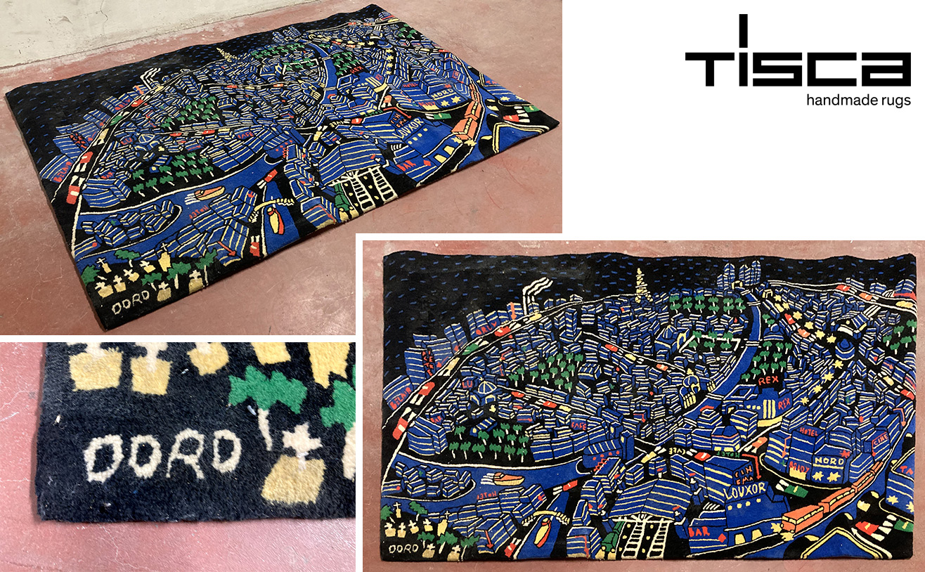 TAPIS DE MARQUE TISCA EN LAINE A FOND DE COULEUR NOIRE A MOTIF DUNE SCENE DE LA VILLE DE PARIS NOCTURNE. SIGNE BAS A GAUCHE "DORO". 209 X 130 CM. ARCUEIL SOUS-SOL POSTE