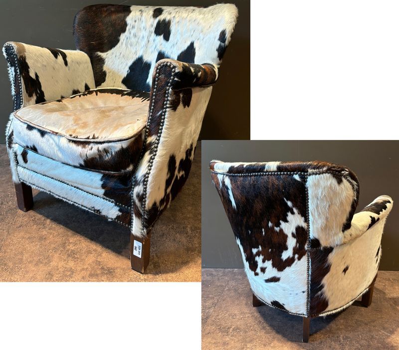 PETIT FAUTEUIL CLUB EN PEAU DE VACHE. USURES. 73 X 67 X 70 CM.