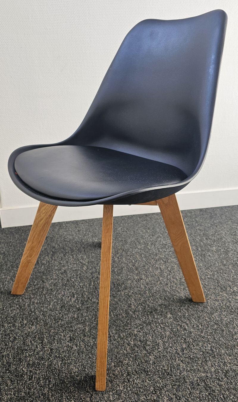 FAUTEUIL DE MARQUE MAISON DU MONDE MODELE CHAISE ICE, ASSISE ET DOSSIER EN POLYPROPYLENE DE COULEUR NOIRE AVEC GALETTE EN SIMILICUIR DE COULEUR NOIRE REPOSANT SUR 4 PIEDS EN BOIS. 82 X 49 X 50 CM.  LOCALISATION -> BAT FK : 1