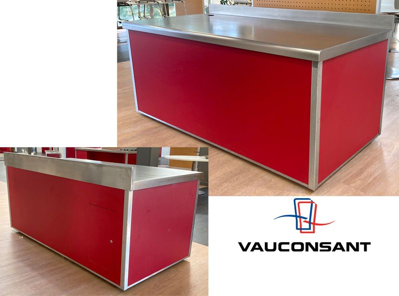 BUFFET ADOSSE DE MARQUE VAUCONSTANT EN INOX ALIMENTAIRE, VERRE ET BOIS LAQUE ROUGE PLATEAU EN INOX, AVEC TRAPPE DE SERVICE COMPRENANT 4 PRISES 230V. 96,5 X 200 X 100 CM.