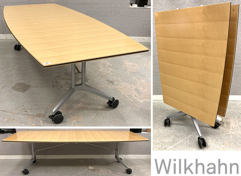 TABLE PLIANTE SUR ROULETTES DE MARQUE WILKHAHN MODELE CONFAIR 440/2, PLATEAU TONNEAU EN 2 PARTIES EN BOIS COULEUR CHENE CLAIR REPOSANT UNE STRUCTURE EN ACIER ET SUR UN PIETEMENT EN ALUMINIUM LAQUE GRIS. 73 X 260 X 110 CM. DIMENSIONS PLIEE : 162 X 110 X 45 CM. LOT EXONERE DE TVA.